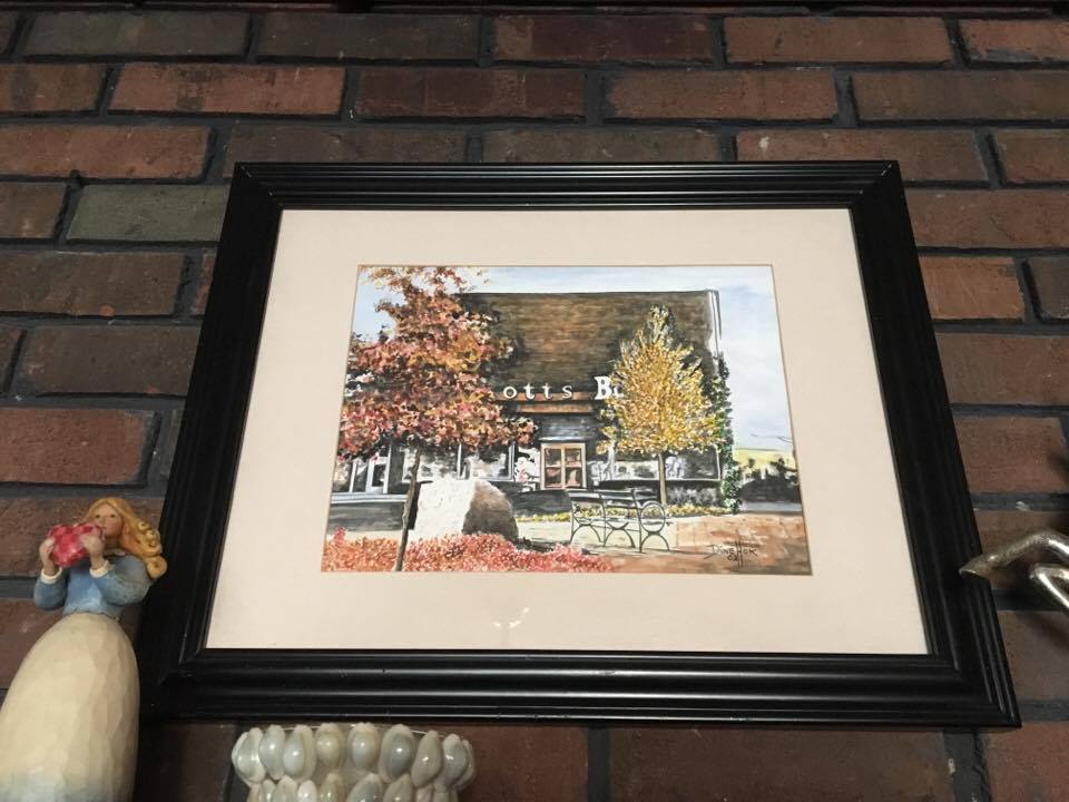 A painting of Scott's Books above Earlene Scott's mantle