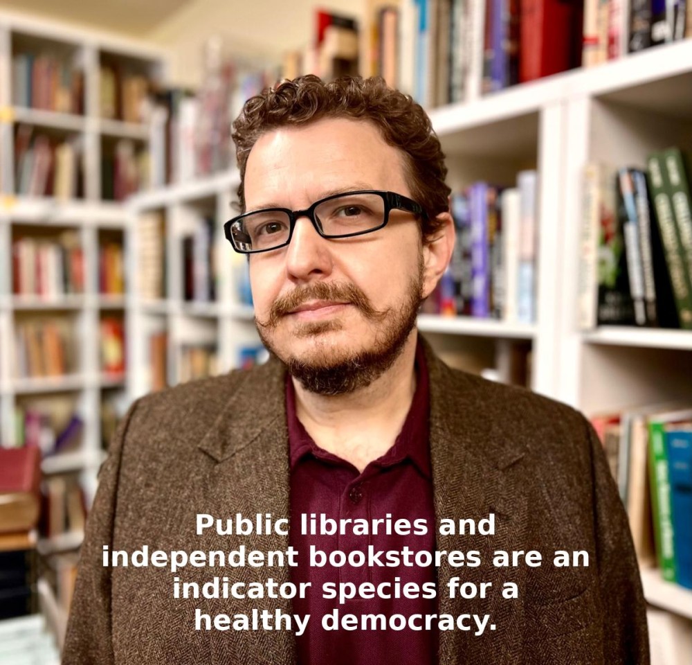 Josh with a background of bookshelves and text