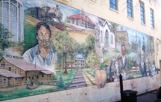 A mural outside Scott's Books featuring prominent Southern authors and buildings